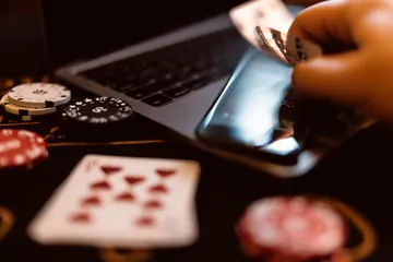 A woman smiling by bright slot machines showing lucky symbols, showcasing the exciting slot offerings at 8777BEF.